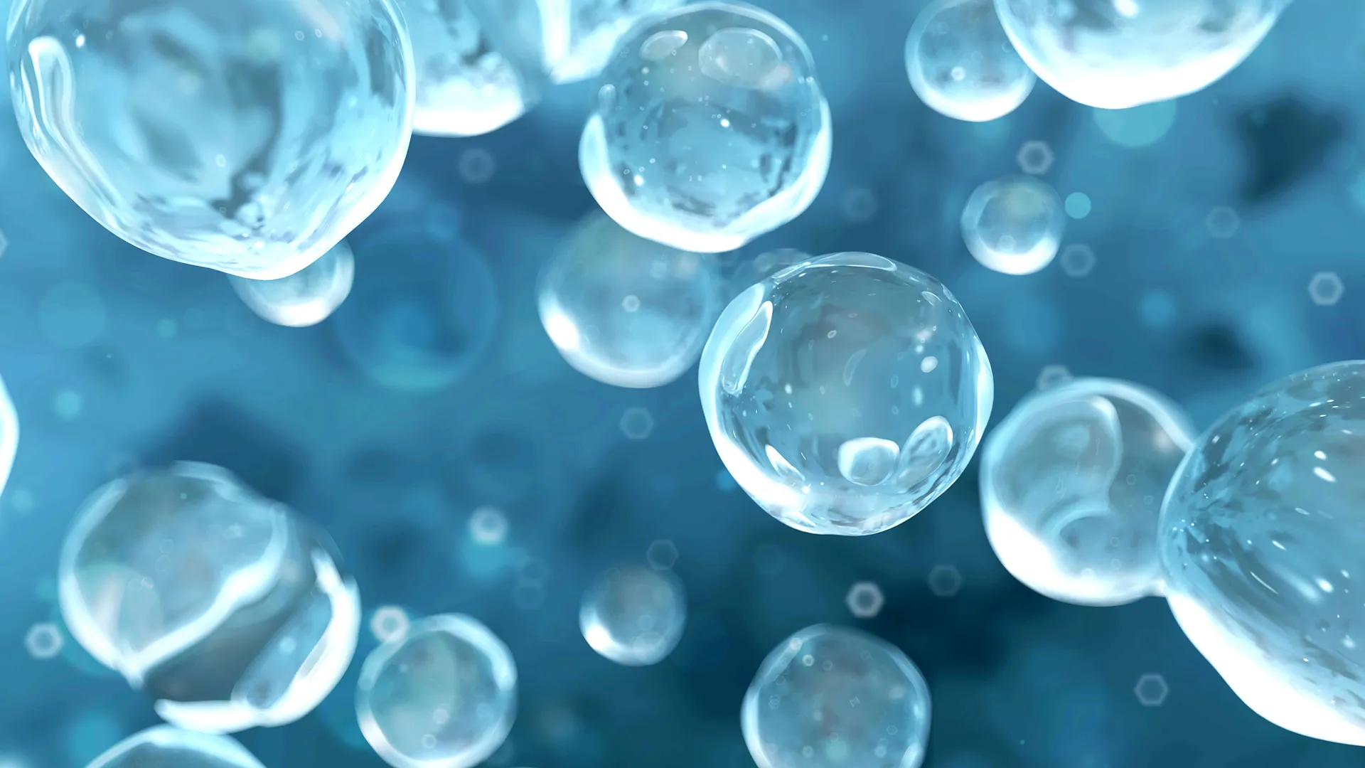 Transparent bubbles float against a blue background, with light reflections and blurring.